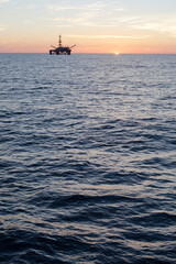 Oil rig at sunset time