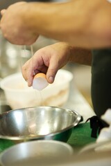 Fine dining food and drink being prepared and displayed in classic white crockery in a kitchen environment,