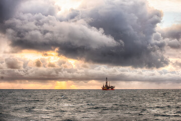 Offshore oil rig at sunset time