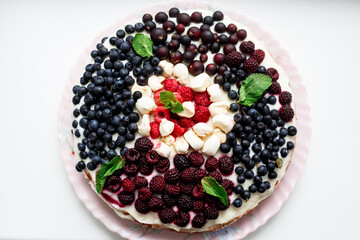 homemade cake with blueberries, raspberries and blackberries