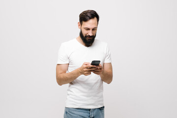  cheerful young man is using a mobile phone.