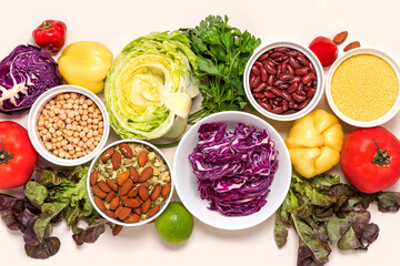Vegetarian food. Food background. Various vegetables, legumes, seeds and nuts on a light background top view, flat lay.