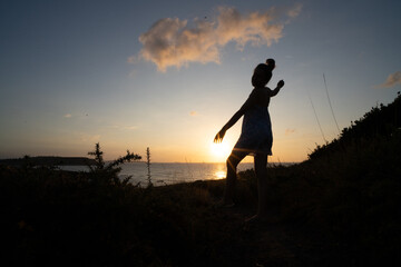 woman enjoying the sunset relaxing with a bow tie