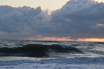 Fototapeta na wymiar Crashing Wave, Sunrise and storm clouds. Amazing