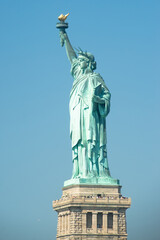 Fototapeta premium Statue of liberty with blue sky during sunny day in summer.