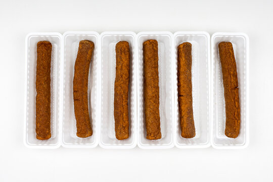 Six fried fricandel in a white plastic container