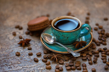 Blue cup of coffee with coffee beans, cinnamon and anise on a brown vintage background.
As background, banner
