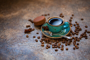 Obraz na płótnie Canvas Blue cup of coffee with coffee beans, cinnamon and anise on a brown vintage background. As background, banner 