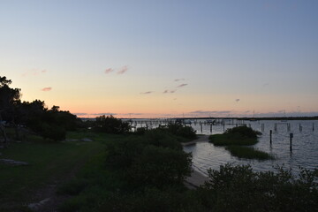 Silhouette of a bridge and Pier Against a Pink Sunset 