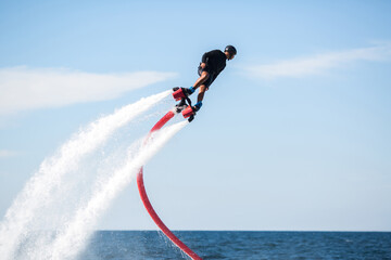 Silhouette of a fly board rider at sea