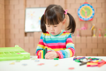 toddler girl play number sticks for homeschooling