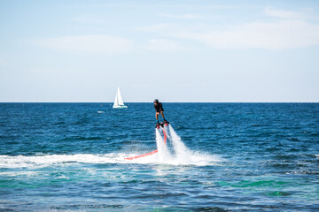 Silhouette of a fly board rider at sea