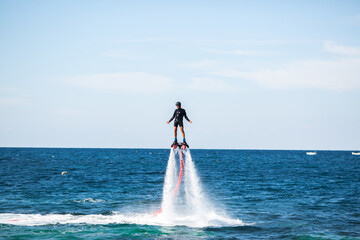 Silhouette of a fly board rider at sea