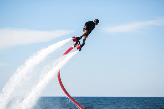 Silhouette of a fly board rider at sea