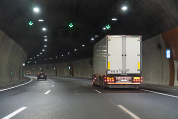 White truck with container inside motorway tunnel