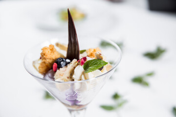 Dessert with biscuits, chocolate and ice cream. Modern cake in a glass