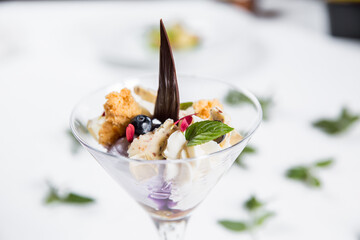 Dessert with biscuits, chocolate and ice cream. Modern cake in a glass