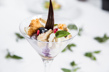 Dessert with biscuits, chocolate and ice cream. Modern cake in a glass