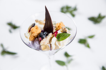 Dessert with biscuits, chocolate and ice cream. Modern cake in a glass