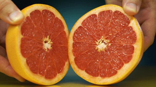 pink grapefruit cut in half. Ripe half of pink grapefruit citrus fruit, sliced grapefruit on blue background,