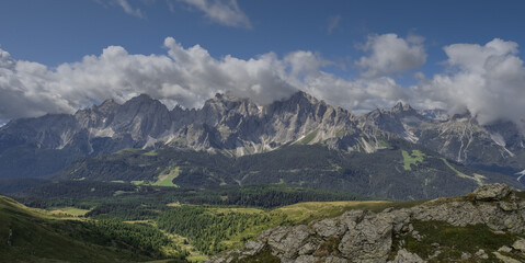 Fototapeta premium View of Sesto Dolomites massif and Tre Cime di Lavaredo iconic summits in Italy as seen from Carnic Alps ridge and passes along the Carnic Peace Trail, Cranic Alps Highroute trek, Austria.