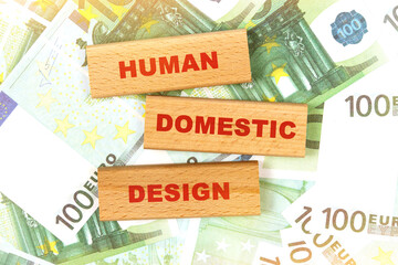 Against the background of euro bills, the text is written on wooden blocks - human centered design