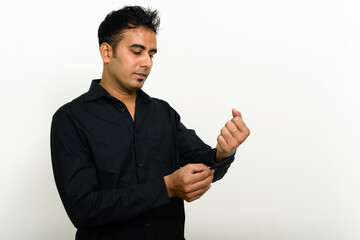 Portrait of handsome Indian businessman against white background