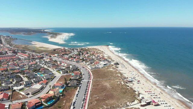 DRONE AERIAL FOOTAGE The marginal riverside, along the mouth of the Cavado River in Esposende, Portugal. The two sides of Restinga de Ofir. One facing the ocean, the other the estuary of C&aacute;vado River.