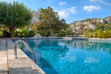 Obraz premium Summer resort swimming pool in a sunny day