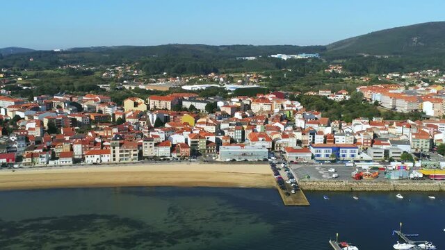 Pobra do Carminal in Galicia.  View of village, beach and marina. Spain. Drone Footage