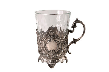 Beautiful old cup holder with glass isolated on white background. Vintage antique things, dishes.