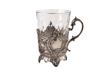 Beautiful old cup holder with glass isolated on white background. Vintage antique things, dishes.