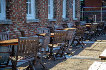 Empty outdoor tables and chairs outside a pub