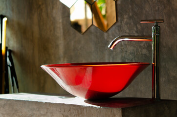 The sun falls Red wash basin and modern faucet,  polished concrete wall and Hexagon shape mirror...