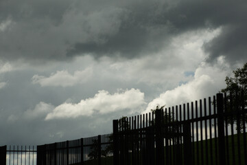 fence and clouds