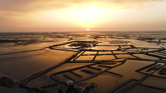 Aerial footage of the amazing salt industry fields in Aveiro, Portugal. Going forward during golden hour with this incredible sunset.
