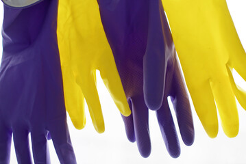purple and yellow rubber gloves on a white background
