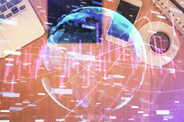 Double exposure of financial chart hologram over desktop with phone. Top view. Mobile trade platform concept.