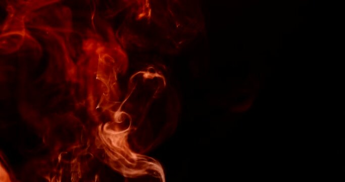 Flames bursting on black background. 4k DCI footage
