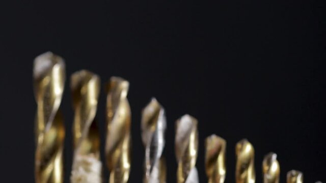 Drill bits close up dolly shot of different sized bits used for drill holes in wood and metal. Close up drill bits for drill. 