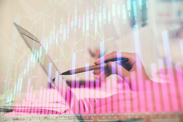 Multi exposure of woman hands typing on computer and financial graph hologram drawing. Stock market analysis concept.