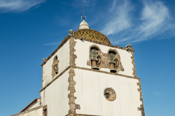 Detail of the facade and singular dome of the bell tower with its arches of the Mother Church of Pedrogão Grande PORTUGAL