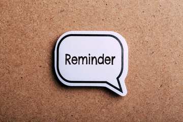 Reminder Speech Bubble Isolated On Brown paper Background