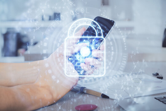 Multi exposure of man's hands holding and using a digital device and lock drawing. Security concept.