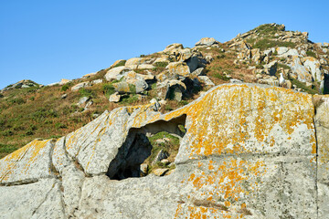 wind eroded stone with green landscape in background © sacho