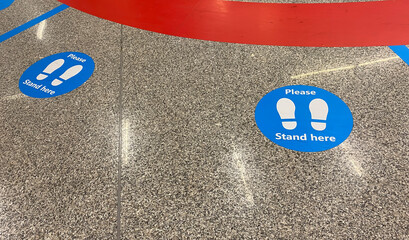 a sticker on the floor that warns to keep social distancing