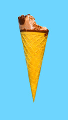 side view fresh chocolate flavor ice cream cone with a bite on a blue background