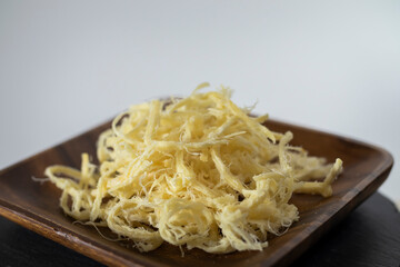 Japanese dried smoked squid in the wooden plate.