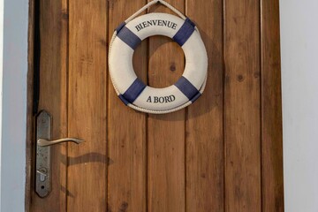 Lifesaver ring on door in unit. Blue and white lifesaver, lifebouy

