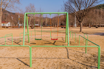 Fototapeta na wymiar Green swing set